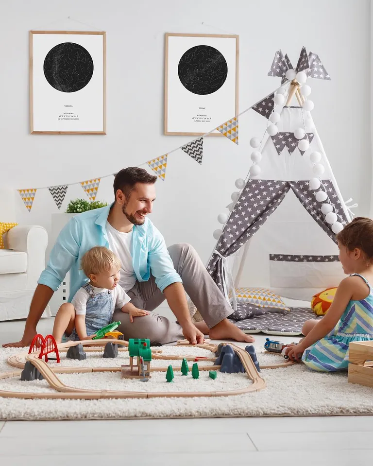 Family is playing while there are 2 star maps in the background