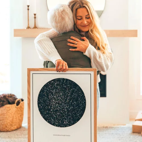 Mother and Daughter Hugging as they Gift a Star Map